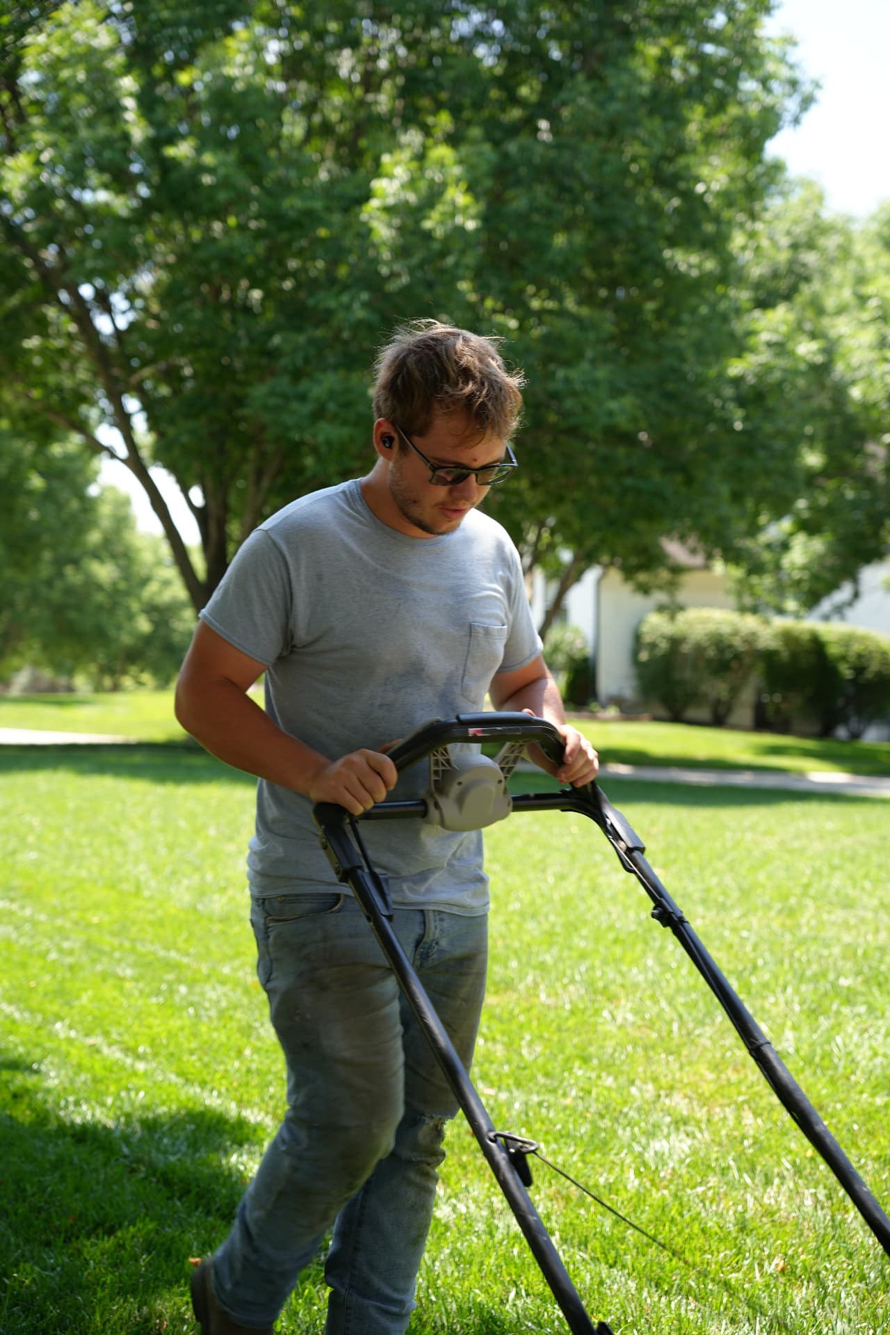 Bluestem crew member mowing a residential lawn in Overland Park